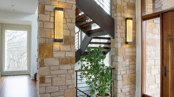 Foyer Featuring Stone Columns and Floating Open Tread Walnut Staircase with Waln