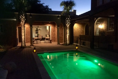 Photo of a mid-sized mediterranean backyard rectangular pool in Jacksonville with a hot tub.