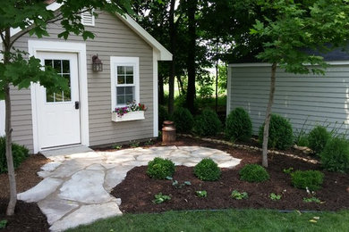 Inspiration for a large traditional shade backyard landscaping in Minneapolis.