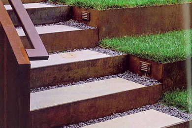 This is an example of a small full sun backyard concrete paver retaining wall landscape in Denver.