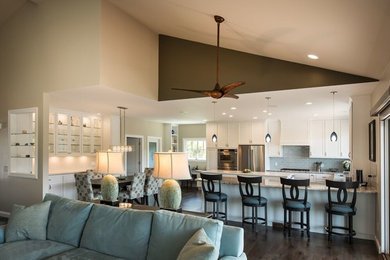 Large trendy u-shaped dark wood floor and brown floor kitchen photo in San Francisco with an undermount sink, recessed-panel cabinets, white cabinets, gray backsplash, subway tile backsplash, stainless steel appliances and an island