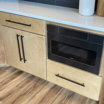 Angled Kitchen Design with Slab Style Cabinets in Pecan Stain