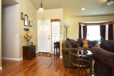 Example of a mid-sized cottage chic medium tone wood floor entryway design in Sacramento with beige walls and a glass front door