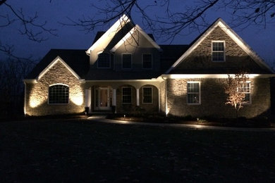 Mid-sized traditional beige two-story stone gable roof idea in Philadelphia
