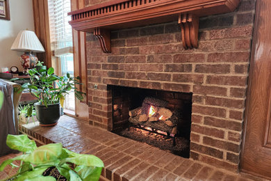 Living room - traditional living room idea in Dallas with a standard fireplace and a stone fireplace