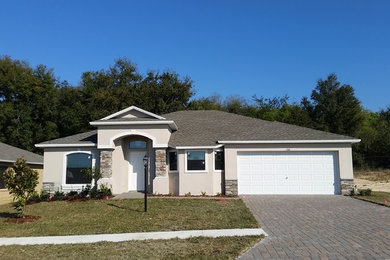 Mid-sized transitional beige one-story wood exterior home photo in Orlando