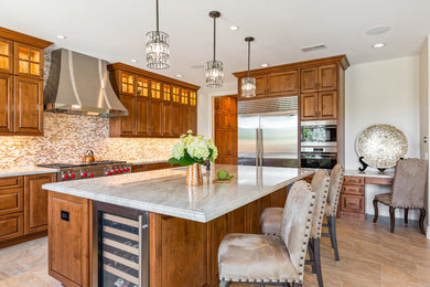 Example of a huge classic u-shaped porcelain tile and beige floor open concept kitchen design in Tampa with an undermount sink, raised-panel cabinets, brown cabinets, quartzite countertops, multicolored backsplash, mosaic tile backsplash, stainless steel appliances, an island and multicolored countertops