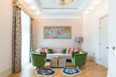 Mid-sized eclectic formal enclosed living room in London with pink walls, medium hardwood floors and brown floor.