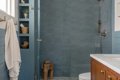 Bathroom - mid-sized 1950s master blue tile and cement tile marble floor, double-sink and wall paneling bathroom idea in San Diego with marble countertops, a hinged shower door and a freestanding vanity