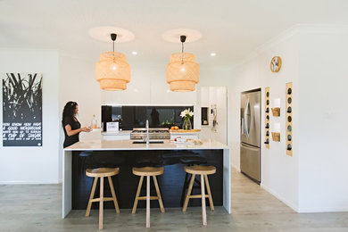 This is an example of a medium sized modern kitchen in Sydney.