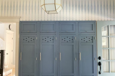 Example of a beach style wallpaper mudroom design in Boston with a blue front door