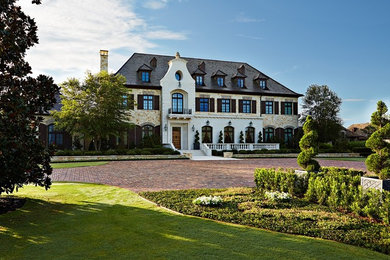 Huge elegant multicolored three-story mixed siding house exterior photo in Tampa with a hip roof and a shingle roof