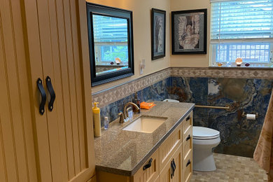 Bathroom - mid-sized contemporary master travertine floor, beige floor and single-sink bathroom idea in Houston with a two-piece toilet, an undermount sink, granite countertops, beige countertops and a built-in vanity