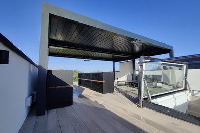 Design ideas for a large modern roof rooftop terrace in Other with a pergola.