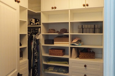 Inspiration for a small coastal gender-neutral carpeted dressing room remodel in Manchester with white cabinets and shaker cabinets
