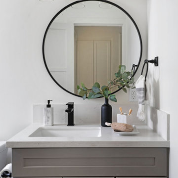 Gray Bath Cabinets with Copper Four-Light Bath Bar