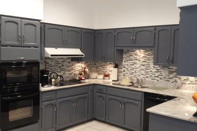 Photo of a small traditional u-shaped separate kitchen in Austin with a double-bowl sink, recessed-panel cabinets, grey cabinets, marble benchtops, multi-coloured splashback, matchstick tile splashback, stainless steel appliances, porcelain floors, with island and beige floor.