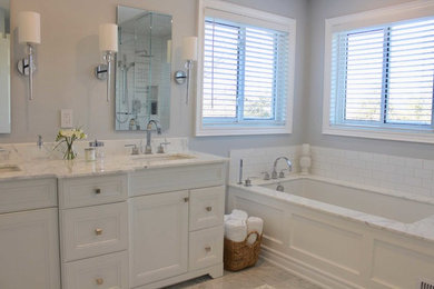 Inspiration for a contemporary white tile and porcelain tile marble floor and gray floor corner shower remodel in Toronto with an undermount tub, a one-piece toilet, blue walls, an undermount sink, marble countertops and a hinged shower door