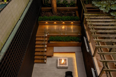 Inspiration for a small contemporary backyard concrete paver patio kitchen remodel in Toronto with no cover