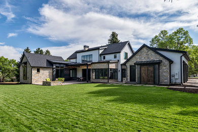 Large cottage white two-story mixed siding exterior home photo in Denver with a shingle roof