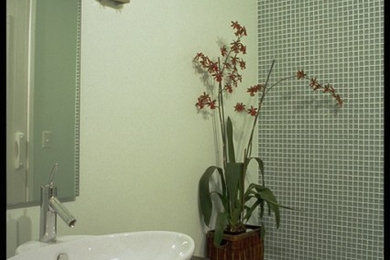 Mid-sized trendy green tile and glass tile porcelain tile bathroom photo in San Francisco with a vessel sink, furniture-like cabinets, dark wood cabinets, a one-piece toilet and green walls