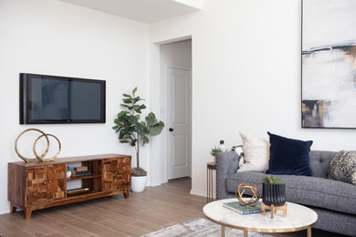 Inspiration for a transitional open concept laminate floor living room remodel in Austin with white walls