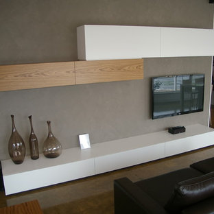 Inspiration for a mid-sized contemporary open concept concrete floor home theater remodel in Adelaide with gray walls and a wall-mounted tv