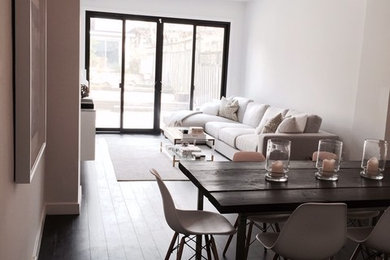 Great room - large 1950s medium tone wood floor great room idea in Toronto with white walls and no fireplace