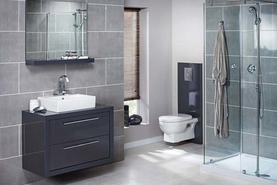 Inspiration for a modern gray tile ceramic tile bathroom remodel in Wichita with onyx countertops and gray walls