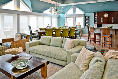 Example of a huge beach style open concept light wood floor living room design in Philadelphia with blue walls, a wall-mounted tv, a standard fireplace and a stone fireplace