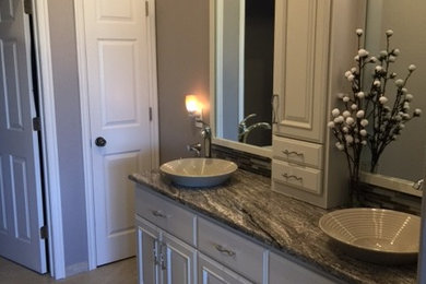 Inspiration for a mid-sized transitional master multicolored tile and mosaic tile ceramic tile and beige floor bathroom remodel in Other with raised-panel cabinets, white cabinets, a two-piece toilet, gray walls, a vessel sink and granite countertops