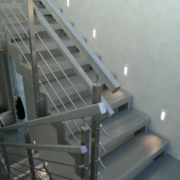 Modern metal stair covered by patina oak