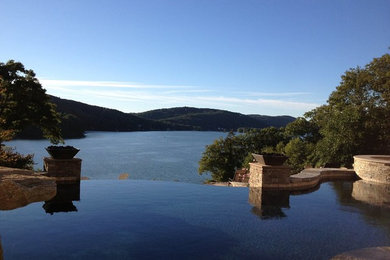 Inspiration for a large backyard custom-shaped infinity pool remodel in New York
