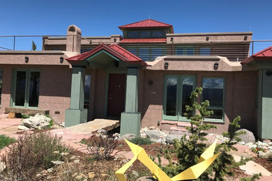 Mid-sized eclectic multicolored two-story concrete fiberboard house exterior photo in Denver with a hip roof and a metal roof