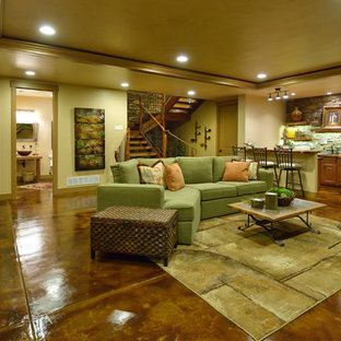Design ideas for a large rustic fully buried basement in Denver with beige walls, concrete flooring, no fireplace and brown floors.