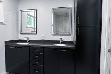 Photo of a small modern shower room bathroom in San Francisco with flat-panel cabinets, black cabinets, a built-in shower, a bidet, grey tiles, porcelain tiles, grey walls, porcelain flooring, a submerged sink, engineered stone worktops, grey floors, a sliding door, grey worktops, a wall niche, double sinks and a built in vanity unit.