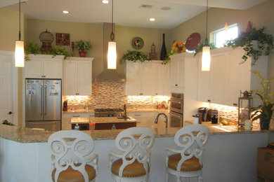 Large transitional u-shaped open concept kitchen photo in Miami with an undermount sink, shaker cabinets, white cabinets, granite countertops, multicolored backsplash, matchstick tile backsplash, stainless steel appliances and an island