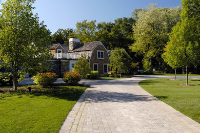 Large traditional front yard full sun driveway in Chicago with concrete pavers for summer.