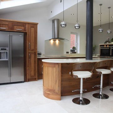 Eye-catching dark wood kitchen with curved island