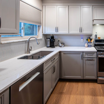 Two-Tone Neutral Kitchen with Quartz Countertop and Soho Picket Backsplash