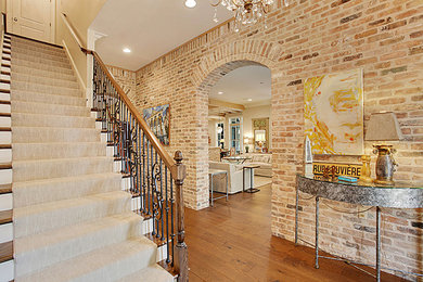 Inspiration for a mid-sized craftsman medium tone wood floor hallway remodel in New Orleans with red walls