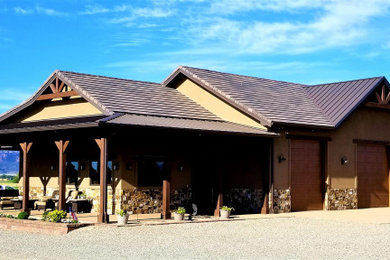 Example of a large farmhouse three-car garage workshop design in Denver
