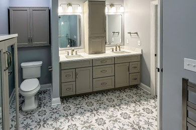 Mid-sized transitional master blue tile and ceramic tile ceramic tile, multicolored floor and double-sink bathroom photo with flat-panel cabinets, gray cabinets, blue walls, an undermount sink, quartz countertops, a hinged shower door, white countertops and a built-in vanity
