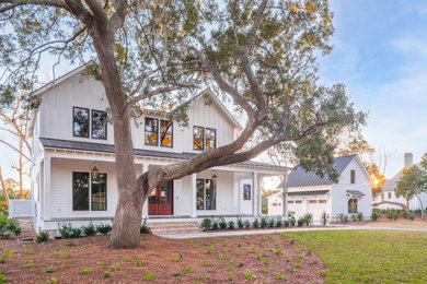 Farmhouse white two-story concrete fiberboard and board and batten house exterior photo in Charleston with a metal roof and a brown roof