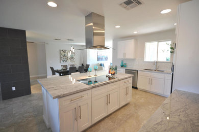 Large trendy l-shaped eat-in kitchen photo in Phoenix with an undermount sink, shaker cabinets, white cabinets, quartzite countertops, white backsplash, glass tile backsplash, stainless steel appliances and an island