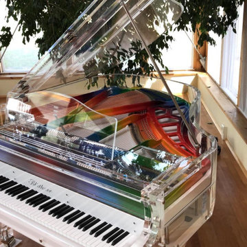 Lucid iDyllic fully transparent baby grand piano with custom rainbow plate