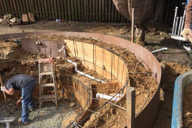 Inspiration for a small backyard custom-shaped natural hot tub remodel in DC Metro