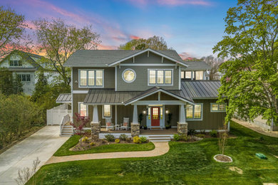 Large craftsman green two-story mixed siding exterior home idea in Other with a metal roof and a gray roof