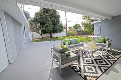 Inspiration for a small mediterranean backyard concrete patio remodel with a roof extension