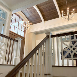 Eingang mit Foyer, beiger Wandfarbe, dunklem Holzboden, Doppeltür, dunkler Holztür, braunem Boden, gewölbter Decke und Treppe in Grand Rapids
